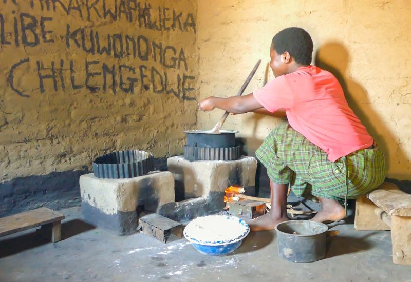 Local woman cooking at home with high efficient cookstove
