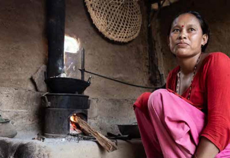 Local nepalese woman cooking with efficient cookstove