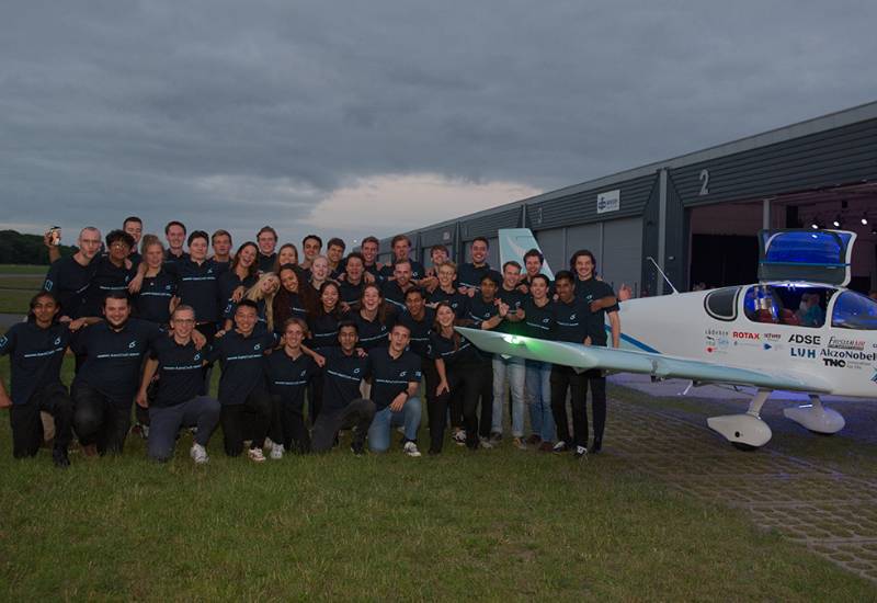 Aerodelft aviation research team posing for photo with model plane