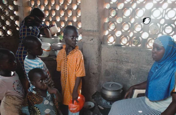 Local community waiting for food made with clean cookstove