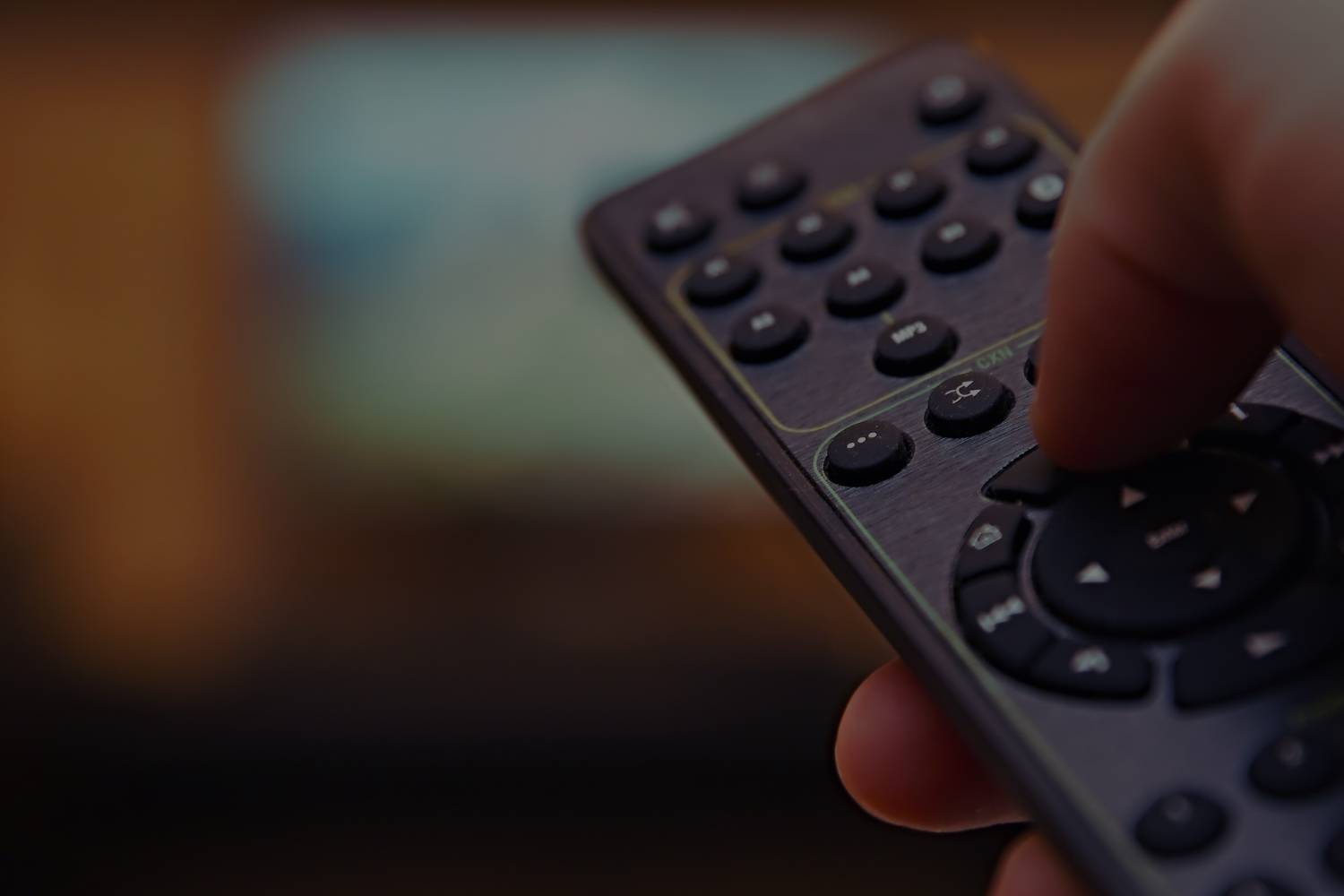 Television remote being pointed at Television