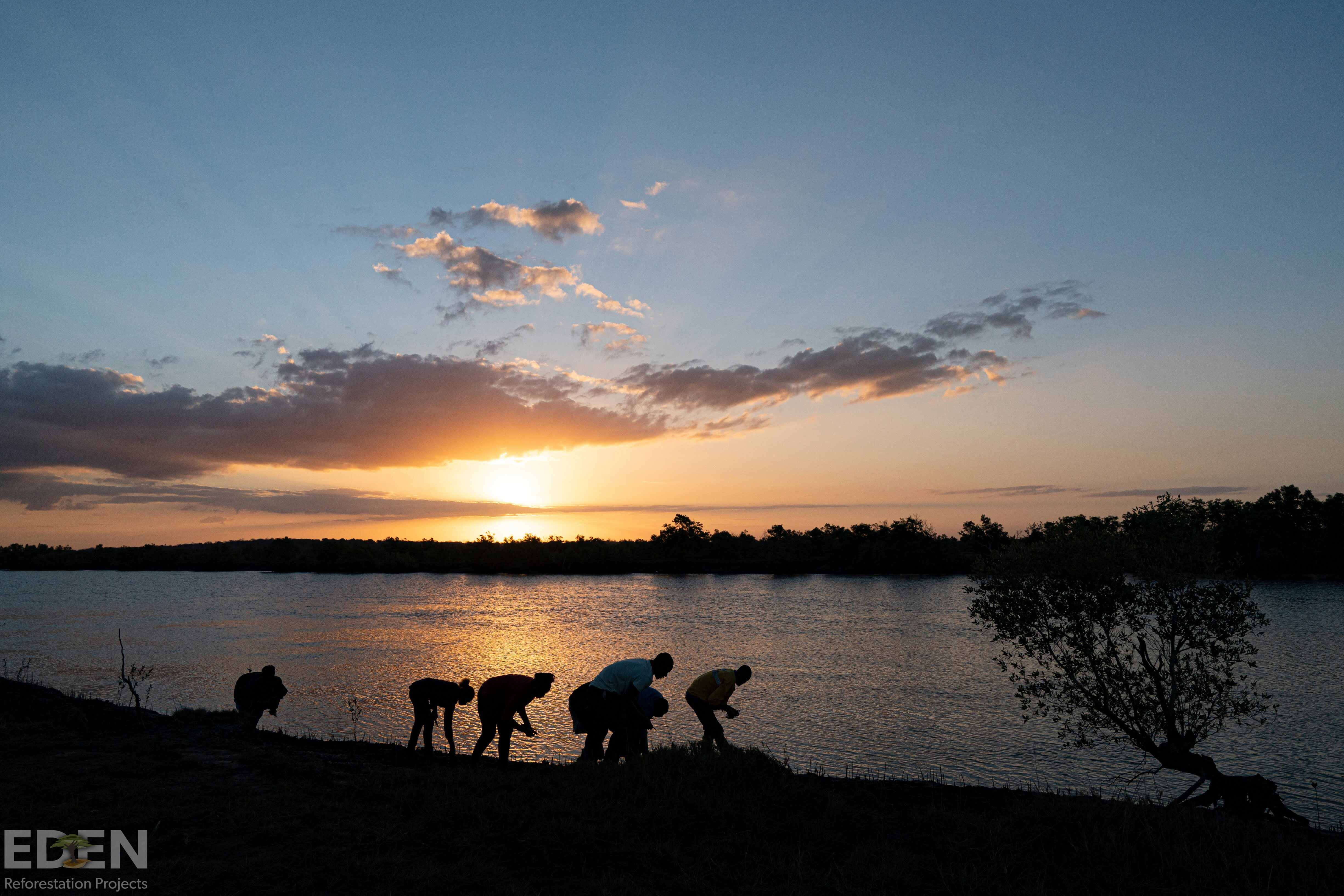 sunset image of lake with people walking